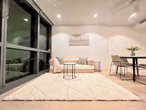 Living Room: coffe tables and three seat sofa can be easily turned into a tatmi inspired comfy Queen size or two single beds