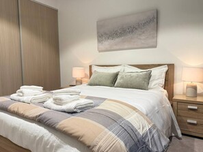 Comfy bedroom with central heating and cooling and ceiling fans