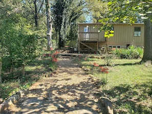 Back view. Wood deck, patio chairs, BBQ grill, table and chairs.