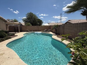 Sun heated pool with lounge chairs and pool lights