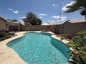 Sun heated pool with lounge chairs and pool lights