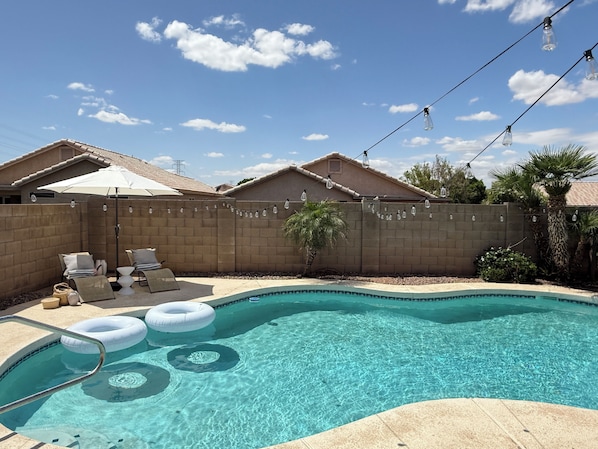 Sun heated pool with lounge chairs and pool lights