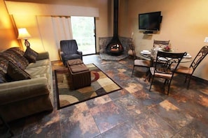 A cozy living area featuring a gas fireplace and dining space, inviting couples and families to relax in a warm, welcoming atmosphere.