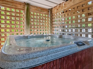 Relax in the bubbly, covered Hot Tub!