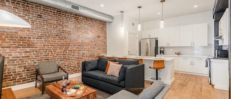 Open-concept living area featuring cozy furnishings, smart TV, and a sleeper sofa.