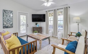 The living room has a smart TV, games and books for entertaining the family.
