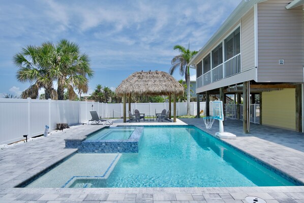 Relax and unwind in your private pool with a luxurious spillover spa.
