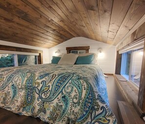 Plush queen sized loft bedroom.Accessed by stairs with a railing.
