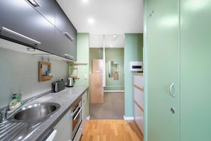 Cook your favourites with ease in the compact kitchen fitted with an oven, microwave, and dishwasher—everything needed for a simple meal.