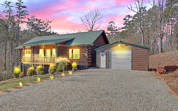 This charming log cabin features serene and peaceful forest views.
