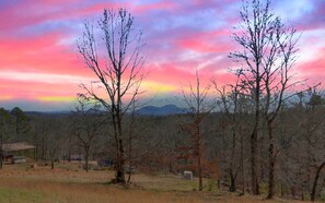 Sunset skies and mountain views—pure serenity from the cabin deck.