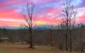 Sunset skies and mountain views—pure serenity from the cabin deck.