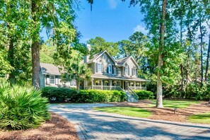 Sweet Carolina Retreat is a charming newly renovated Lowcountry style home on a beautiful expansive lot. After parking in the paver driveway that holds up to 6 cars, unload your cars under the shade of a live oak tree with distinctive Spanish moss.