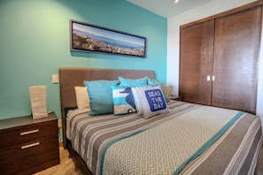 Master bedroom with a king-size bed and its own private bathroom