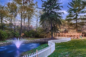 Pond view with fire pit area