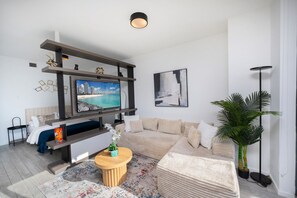 This modern apartment offers a comfortable living space and a private sleeping area for a perfect stay