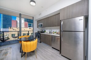 This apartment features a modern kitchen with all essentials and a bright dining nook