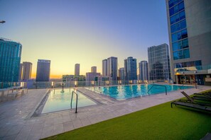 Experience magical evenings by our rooftop pool with incredible city views