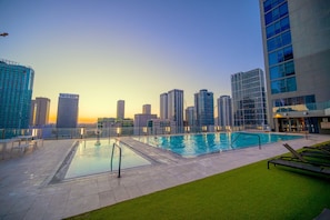 Experience magical evenings by our rooftop pool with incredible city views
