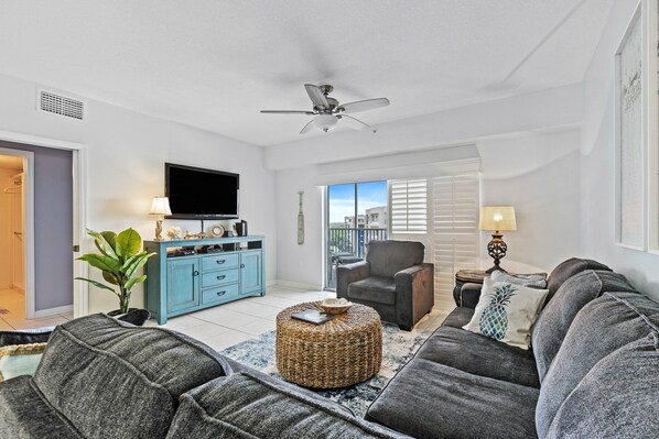 Spacious living room area with access to balcony.