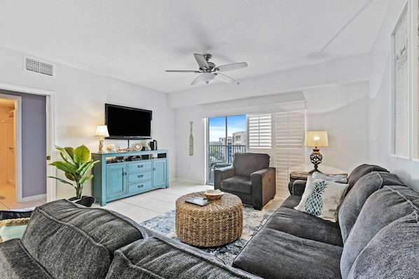 Spacious living room area with access to balcony.