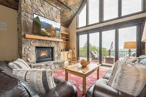 Large Well Ligh Living Room with Leather Seating and Huge Smart LV Over the FirePlace