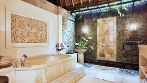 Serene master bathroom with soft lighting and calming rain views