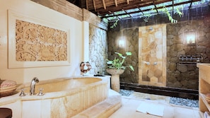 Serene master bathroom with soft lighting and calming rain views