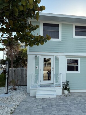 Front door of Family Tides with outdoor shower to wash the sand off