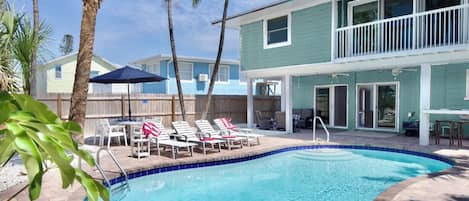 Lounge under the palm trees at the pool