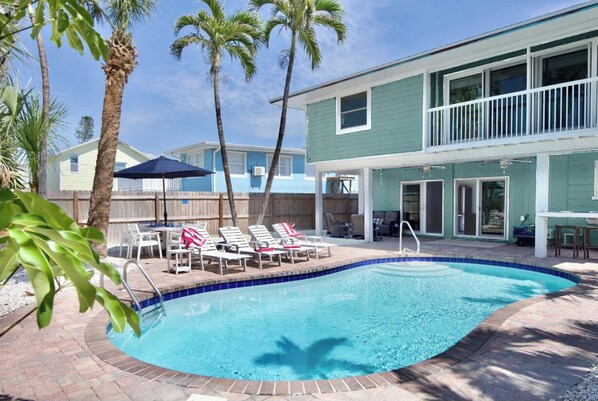 Lounge under the palm trees at the pool