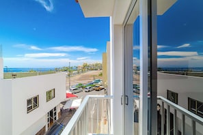 Private Balcony with partial Ocean View and a peek at the Vibrant Neighbourhood below.