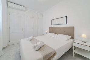 Peaceful Bedroom with Fresh Linens, AC & Plenty of Storage.