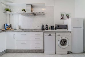 Fully Equipped Kitchen with Fridge, Dishwasher, Washing Machine, Coffee Maker & More.