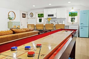 Living Room: Relax and unwind in this spacious open-concept living area, perfect for games and gathering.