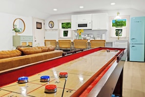 Living Room: Relax and unwind in this spacious open-concept living area, perfect for games and gathering.