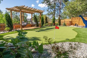 Outdoor Putting Green and Egg Swings for lounging. 