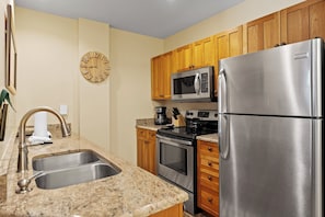 Full kitchen featuring stainless steel appliances.