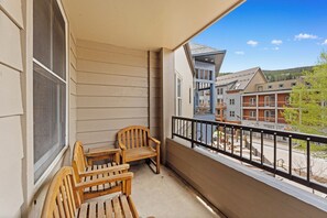 Private balcony with outdoor seating overlooking River Run Village center.