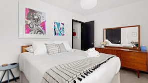 King bedroom with fresh linens and workspace