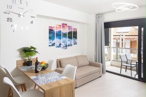 Modern Lounge with Smart TV & Artwork
Relaxing living space with wall art, flat-screen TV, and access to balcony.