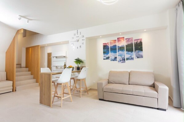 Open-Plan Living Room with Dining Area
Stylish and spacious living area with modern furniture, dining space, and natural lighting.

