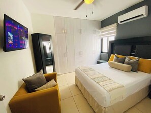 Second bedroom with Smart TV, spacious closet space,  and A/C