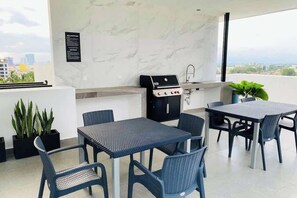 The rooftop lounge also has a shared covered dining area and BBQ grill