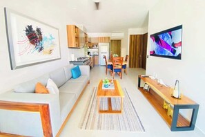 The sitting area has a comfy sofa and Smart TV