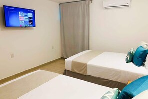 The second bedroom has 2 double beds and a Smart TV