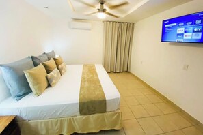 Master bedroom with a king bed and Smart TV