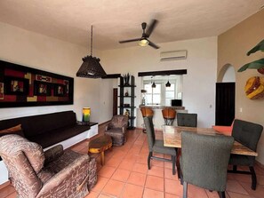 The open floor plan seamlessly connects to the dining area, with a table for four