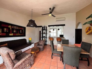 The open floor plan seamlessly connects to the dining area, with a table for four