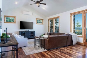 Upper-level living area with smart TV, indoor fireplace, Deck, and stunning view of Flathead Lake!
